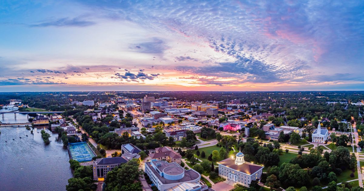 Appleton at sunset, with Lawrence University's Main Hall and the Fox River in the foreground