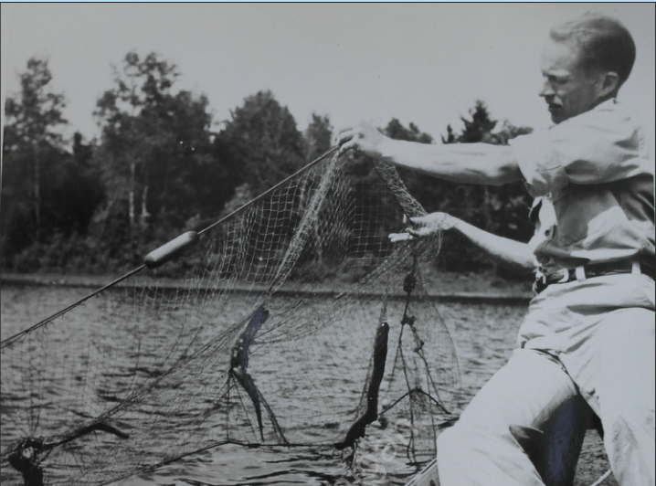 Vernon Applegate handling a net from a boat